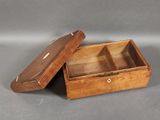an old wooden box with two compartments sitting on a gray surface