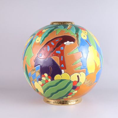 a colorful vase with a painting on it on a white surface