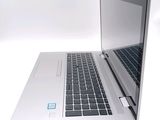 a laptop computer that is open on a white surface