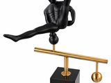 the figurine of a man is balancing on a balance beam