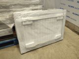 a television sitting on a pallet in a warehouse