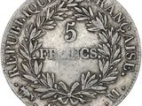 a silver coin with a laurel wreath on top of it