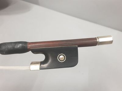 an image of a close up of a violin bow on a table