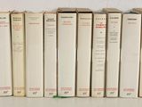 several books are lined up in a row on a shelf