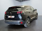 the rear end of a black suv parked in a showroom