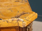 a close up of a marble top on a wooden table