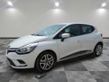 a white car is parked in a room with a checkered floor