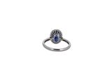 a close up of a ring with a blue stone on it