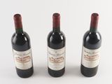 three bottles of wine sitting next to each other on a table