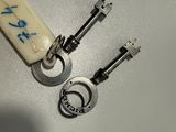 two keys and a keychain on a table