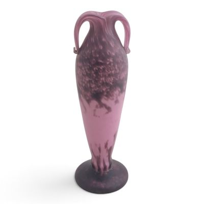 a purple vase that is sitting on a black stand