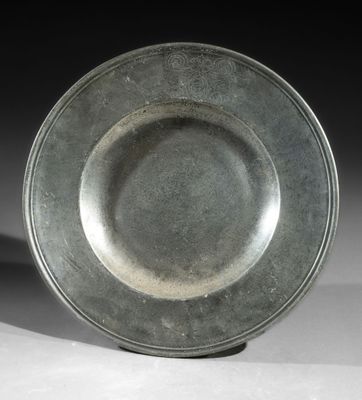 a silver plate sitting on top of a white table