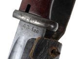 a close up of a knife with a wooden handle