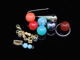 a lot of different colored beads and charms on a black surface