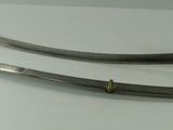 two swords are displayed on a white surface in a display case
