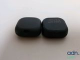an image of a couple of black remote controls sitting on top of a table