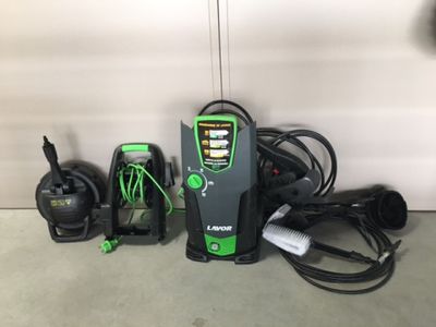 a green and black electric charger sitting next to other electrical equipment