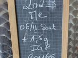 a chalk board with writing on it hanging on a wall