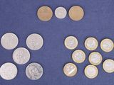 a lot of coins that are on a blue surface