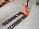 a fork lifter sitting in a garage next to a pile of wood