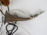 a horn and a string on a white table