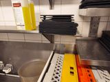 a sink in a kitchen with a lot of dishes on it