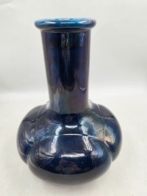 a blue vase that is sitting on a table