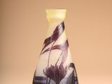 a vase with a bird on it sitting on a table