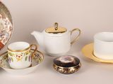 many different types of tea cups and saucers on the table