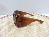 brown sunglasses on a wicker tray with a white background