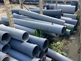 a pile of pipes sitting on the ground next to each other