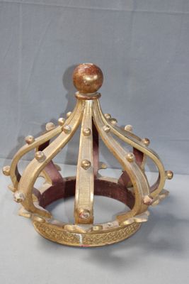 a gold crown sitting on a white surface