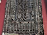 a rug on display on a red table