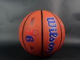a close up of a basketball on a table with a gray background