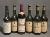 six bottles of wine are lined up in a row on a table