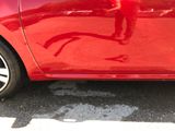 a red car that is parked on the side of the street