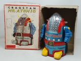 a toy robot that is sitting next to a box