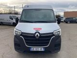 the front of a white van parked in a parking lot