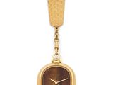 a close up of a gold watch with a red and green face