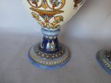 two vases that are sitting on a table