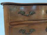 a wooden chest of drawers with brass hardware on the drawers