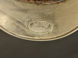 a close up of a silver plate with a logo on it