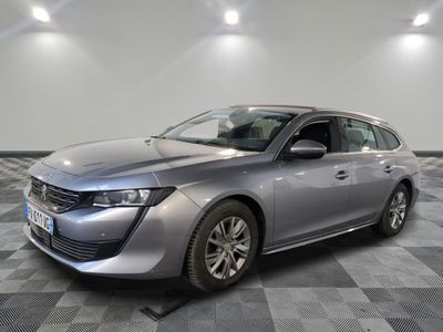 a silver car parked in a room with a checkered floor