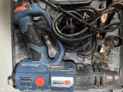 a blue and black electric drill and other tools in a box