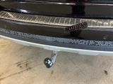 the rear end of a black car with a remote control on it