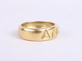 a close up of a gold ring with the word ' a ' inscribed on it