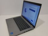 a laptop computer sitting on a table with a blue screen