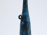 a blue vase sitting on top of a white table