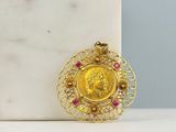 a close up of a gold coin on a marble block