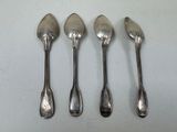 four spoons are lined up in a row on a table